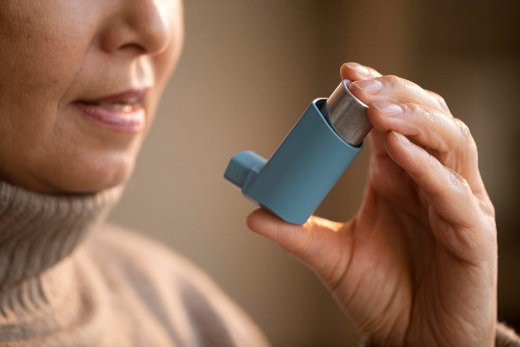 Een vrouw gebruikt een puffer voor haar astma
